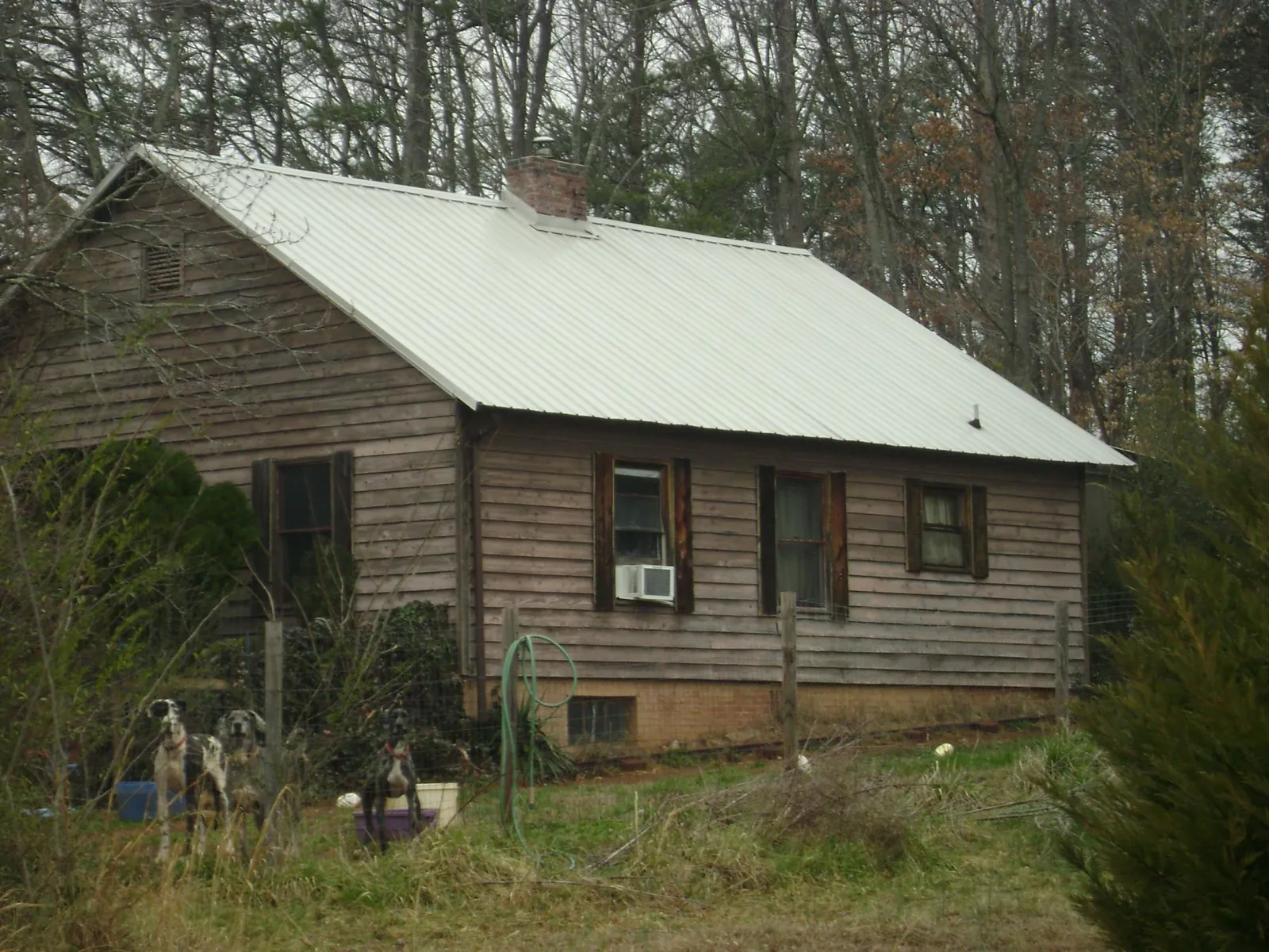 White metal roof on an old wood sided farmhouse, from a Metal Roof Installation job in Kodak